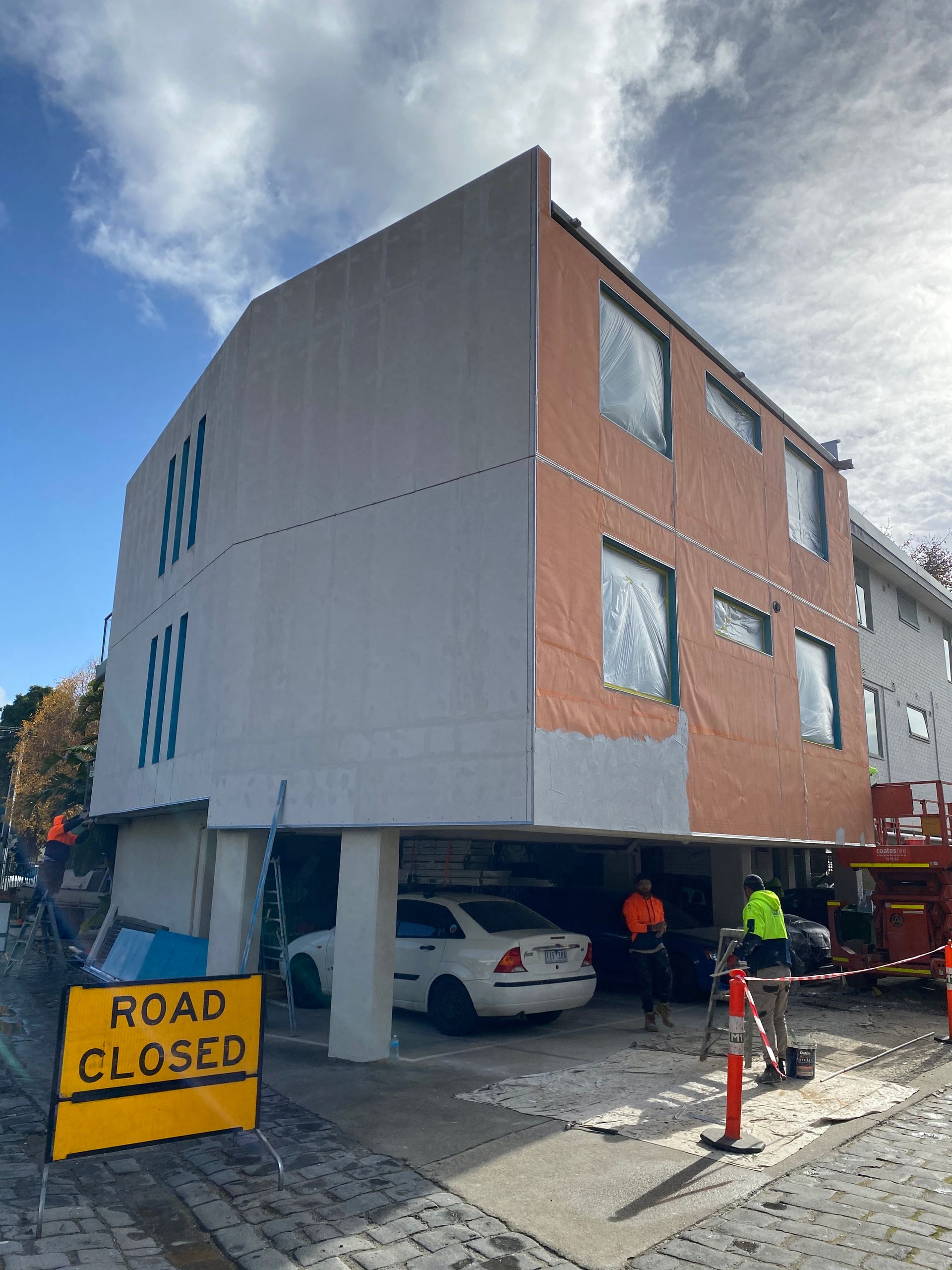 A yellow road closed sign is in front of a building