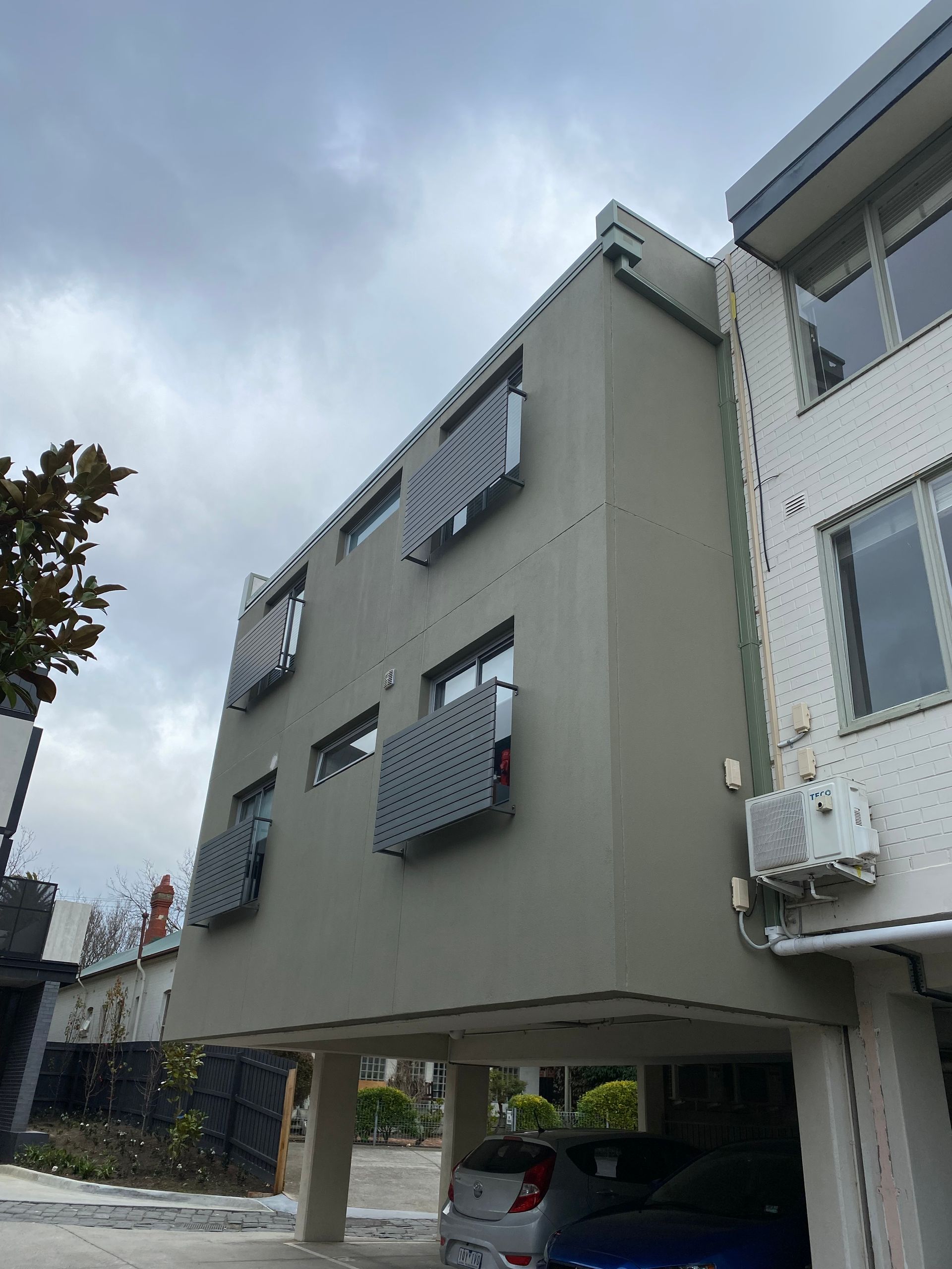 A building with a lot of windows and cars parked in front of it