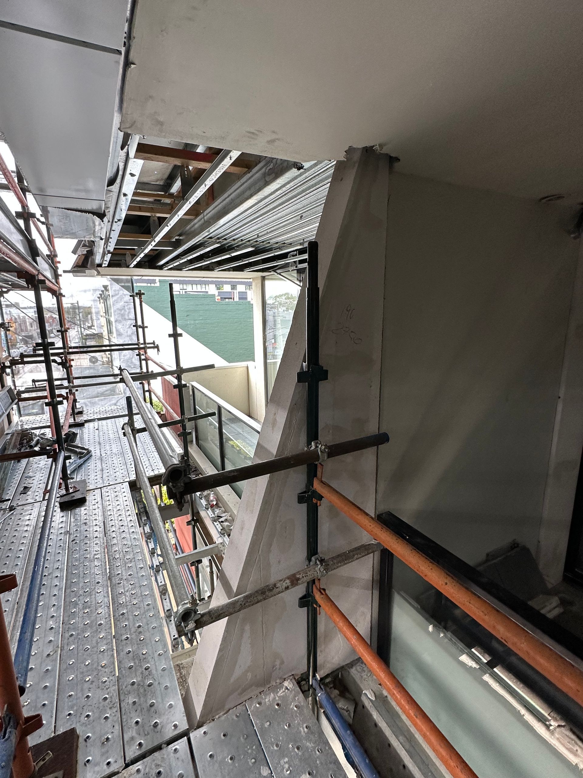 A building under construction with scaffolding and a window
