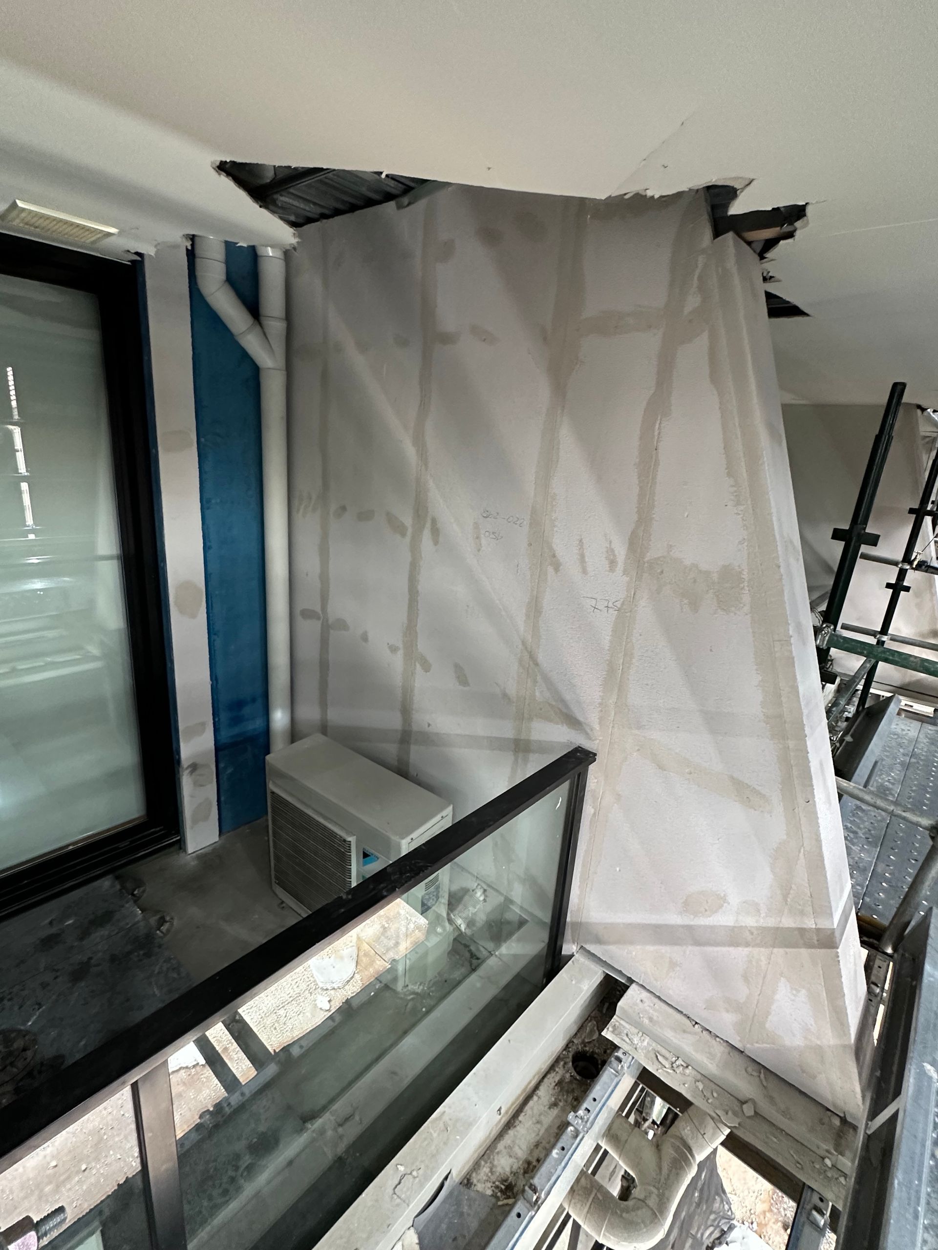 A building under construction with a balcony and stairs