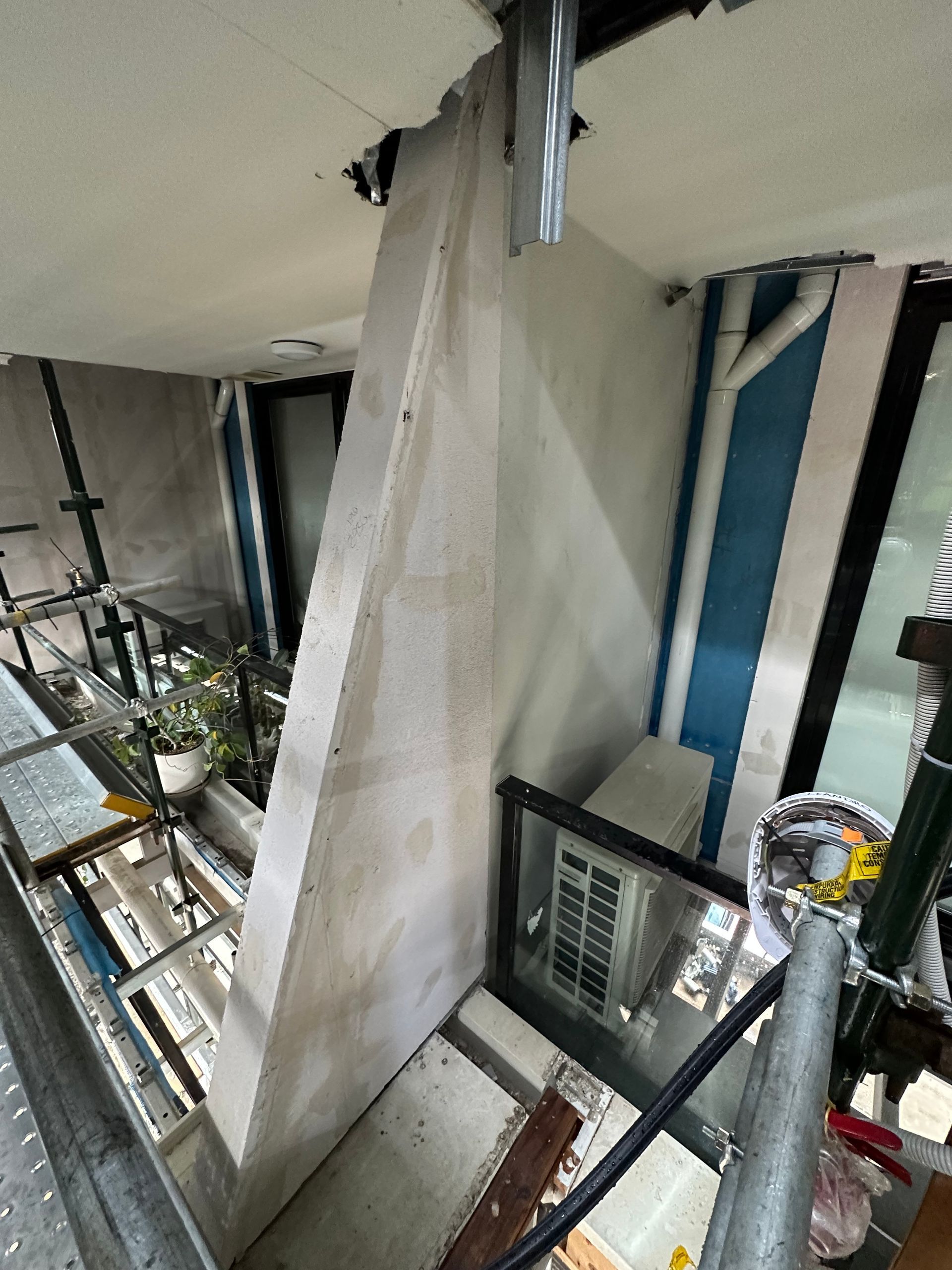 An aerial view of a building under construction with scaffolding.