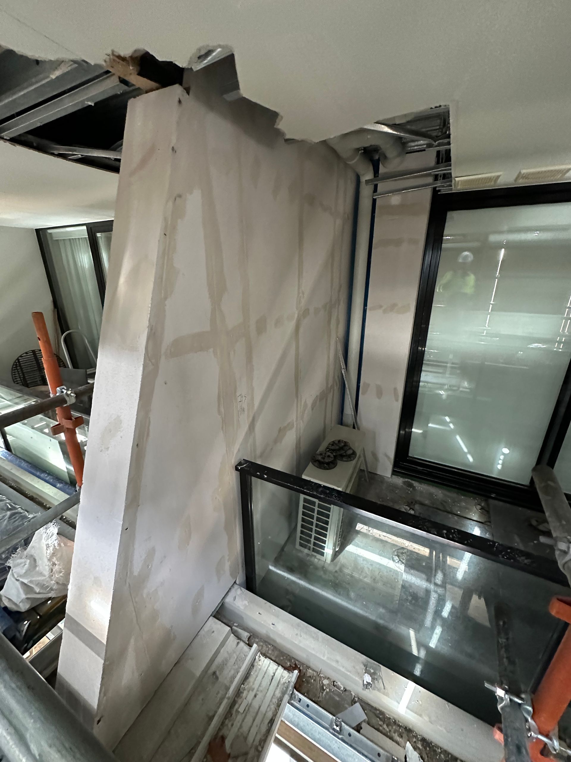 A room with a ceiling that has a hole in it