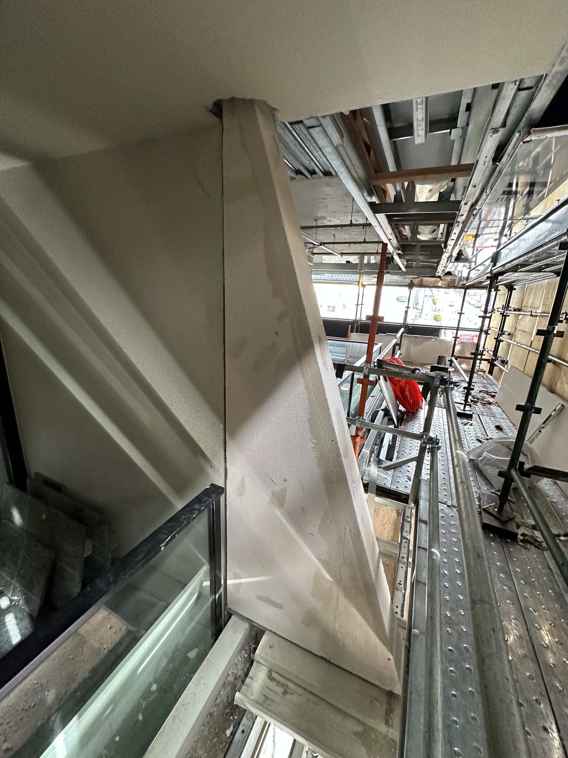 A staircase is being built in a building with scaffolding.