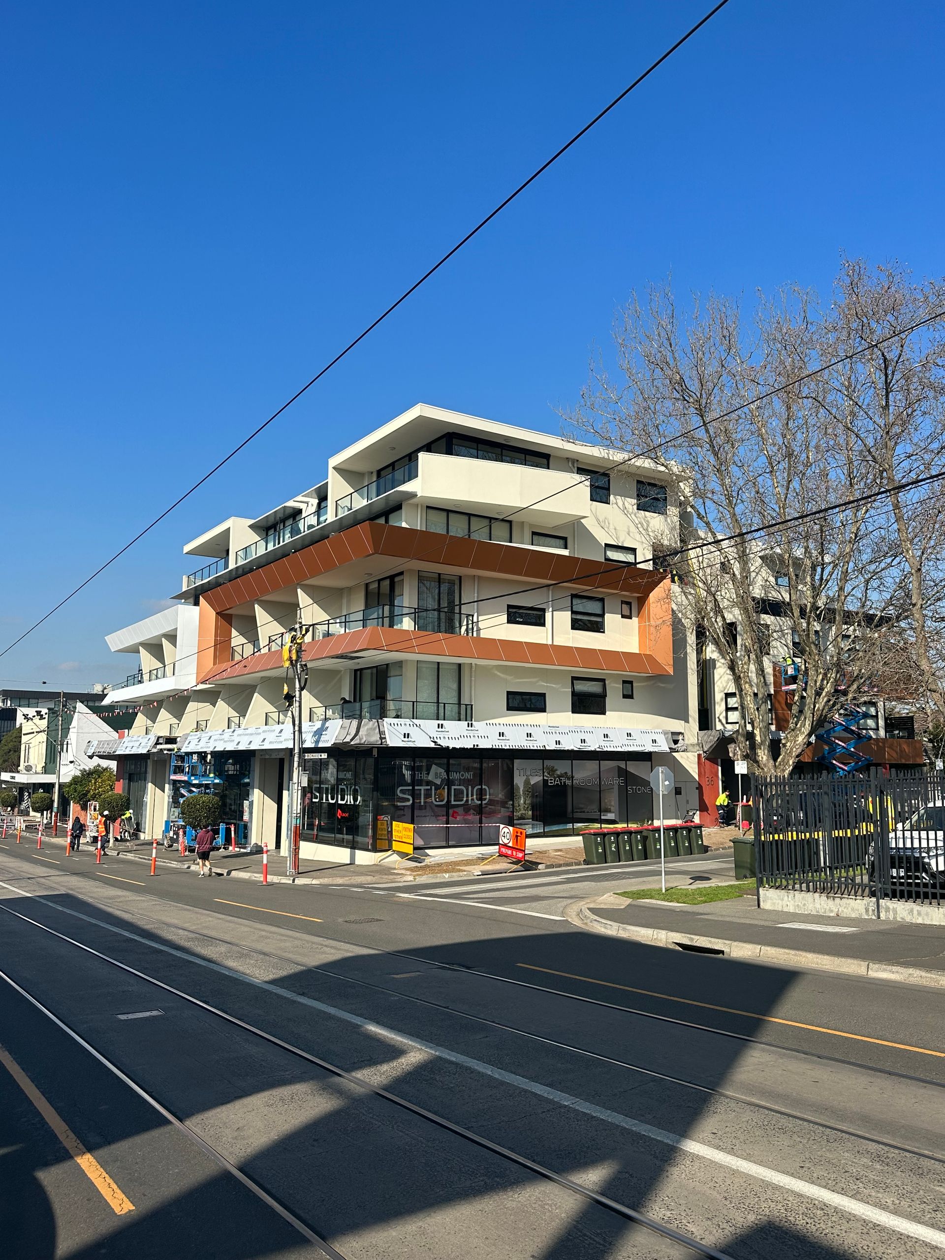 A building on the corner of a street with a blue sky in the background