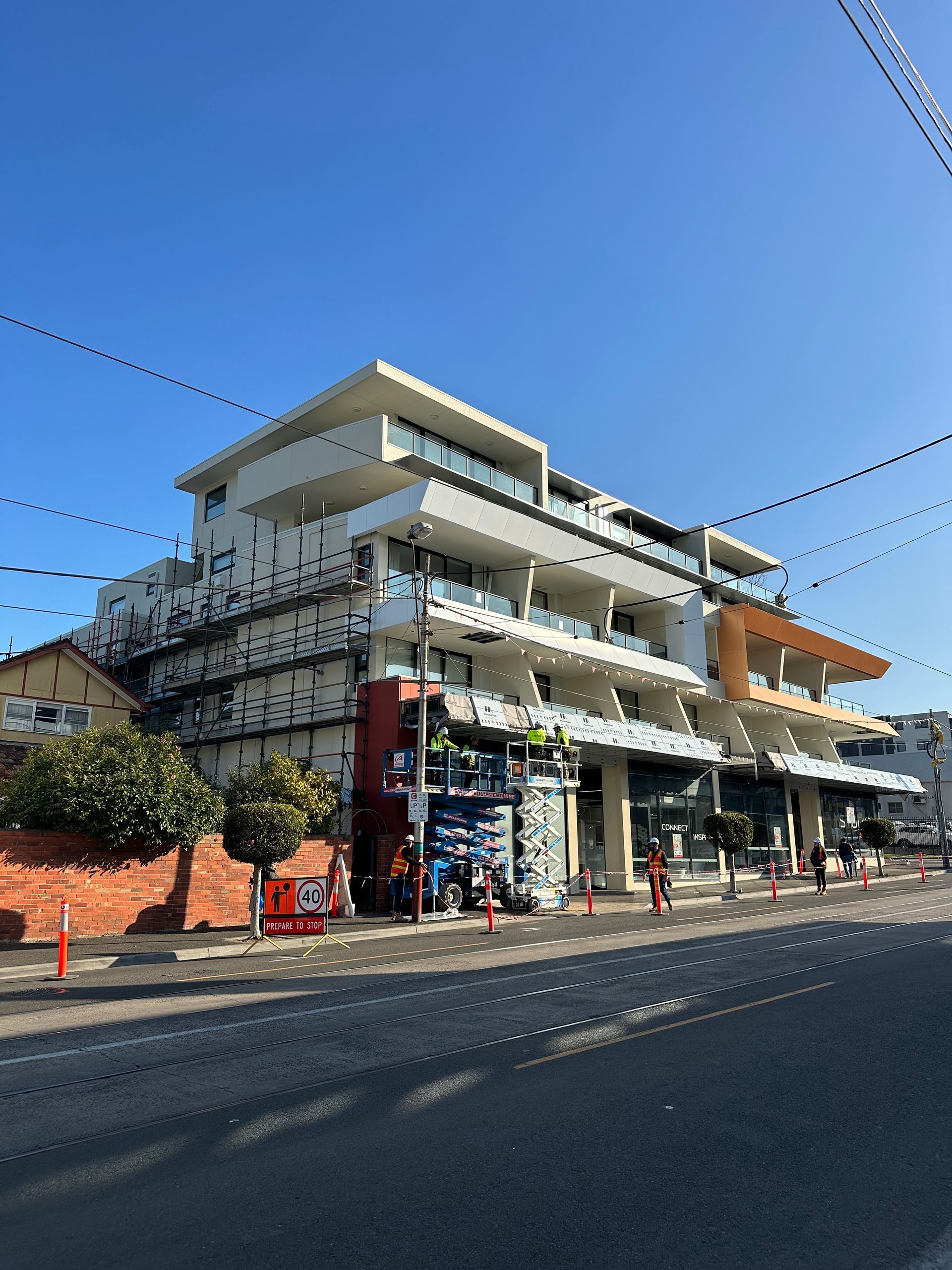A large building is being built on the side of the road.