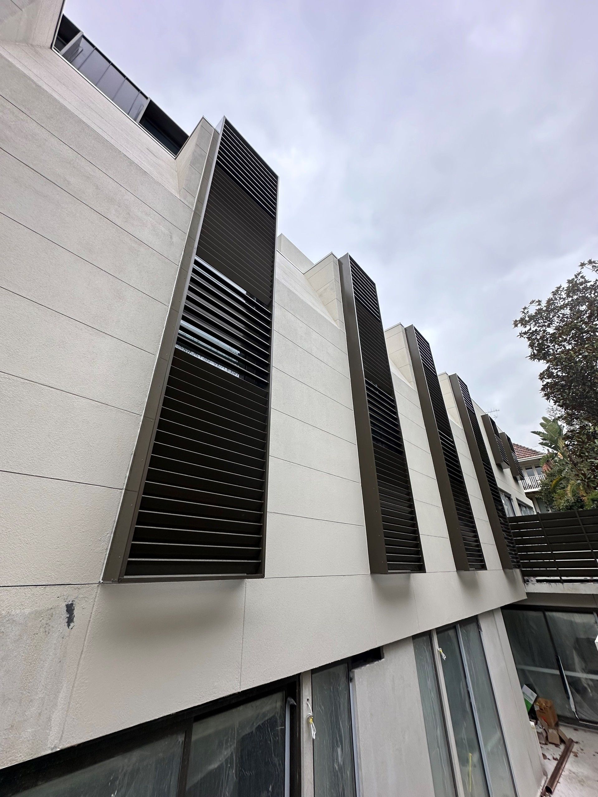 A building with a lot of windows and shutters on it