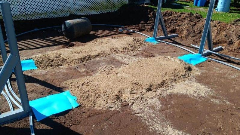 A swimming pool is being built in a backyard.