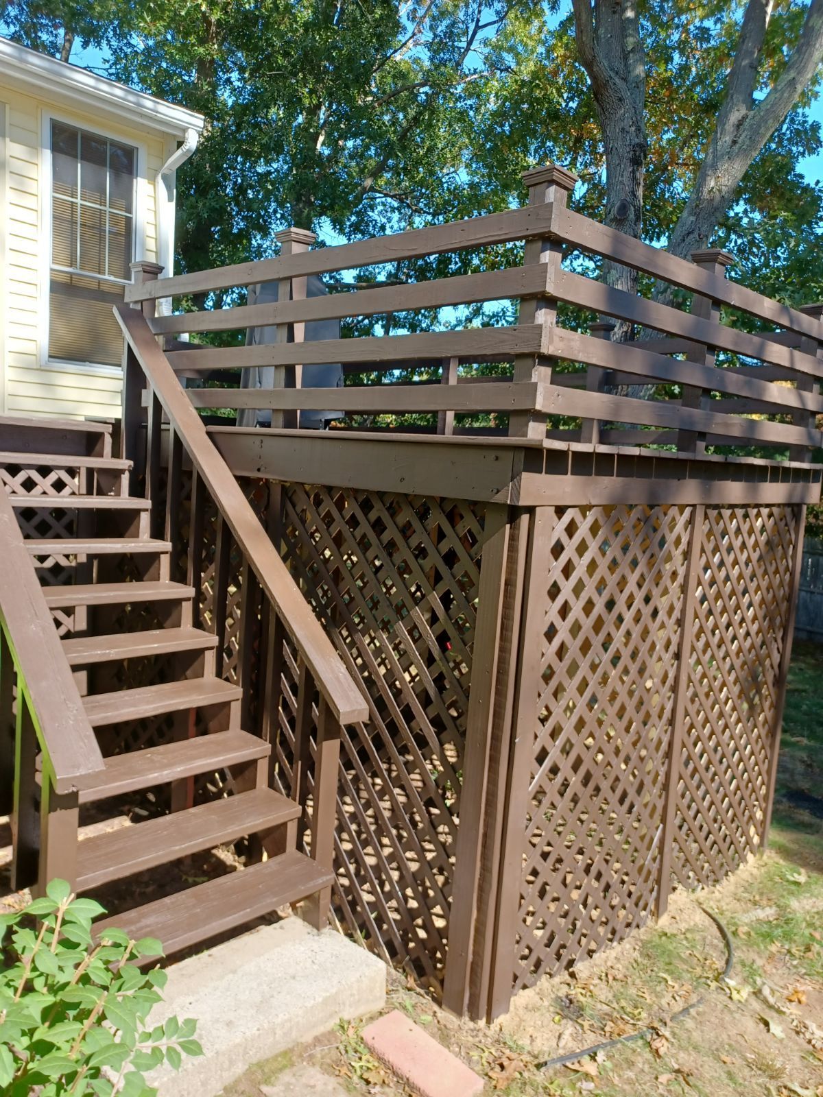 A wooden deck with stairs leading up to it