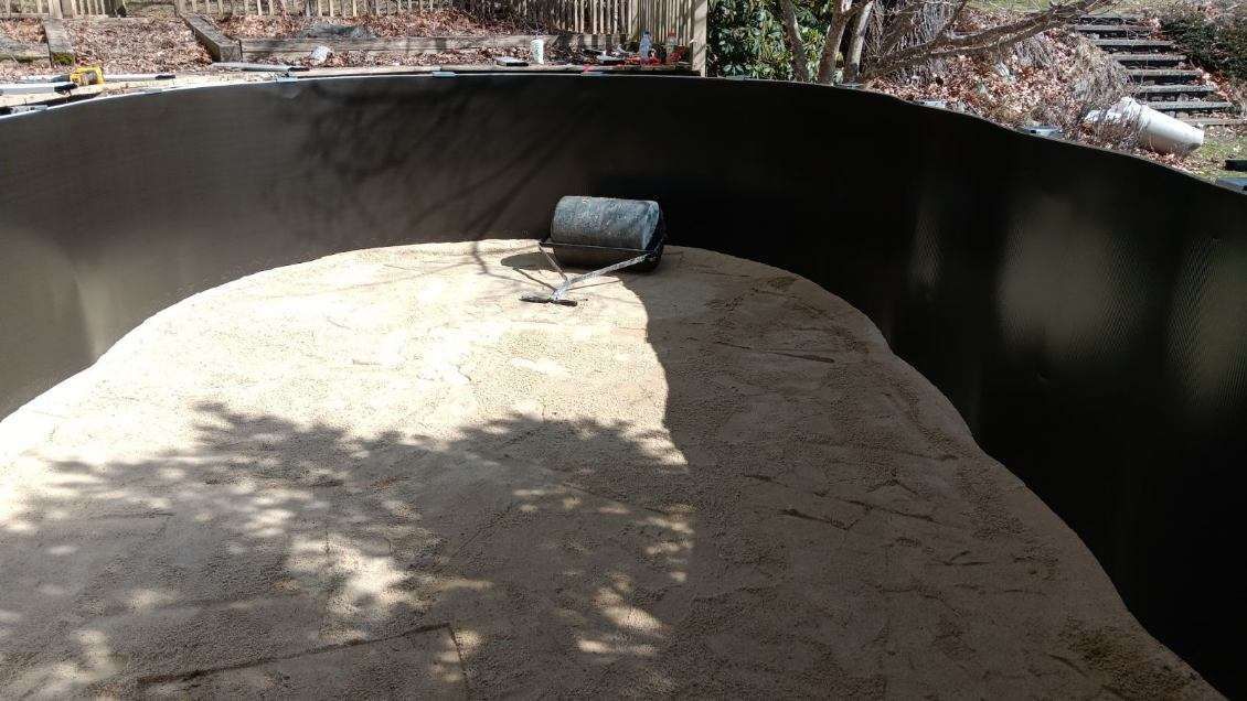 A large pile of sand is sitting in the middle of a pool.