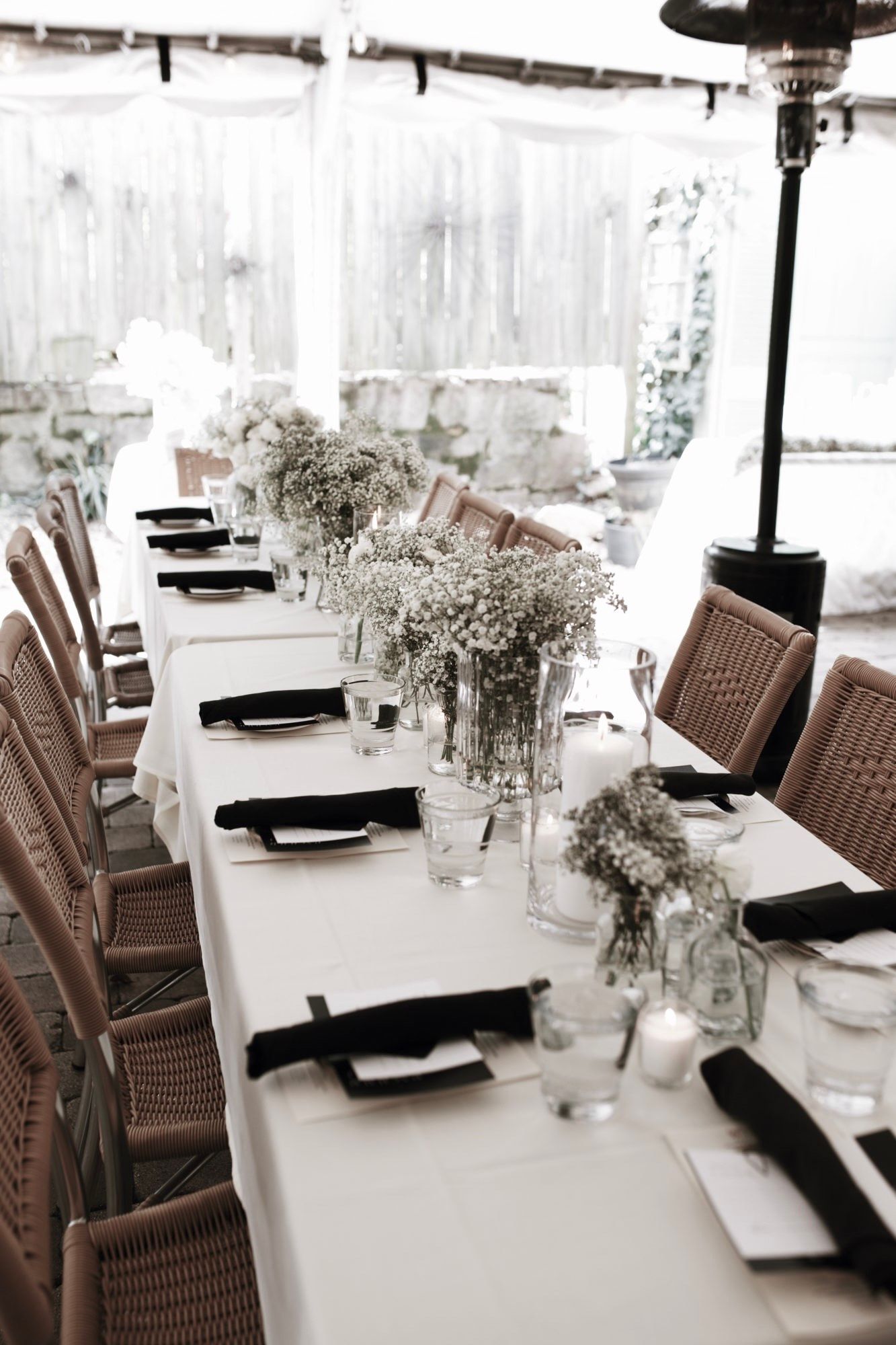A large room with tables and chairs set up for a wedding reception.