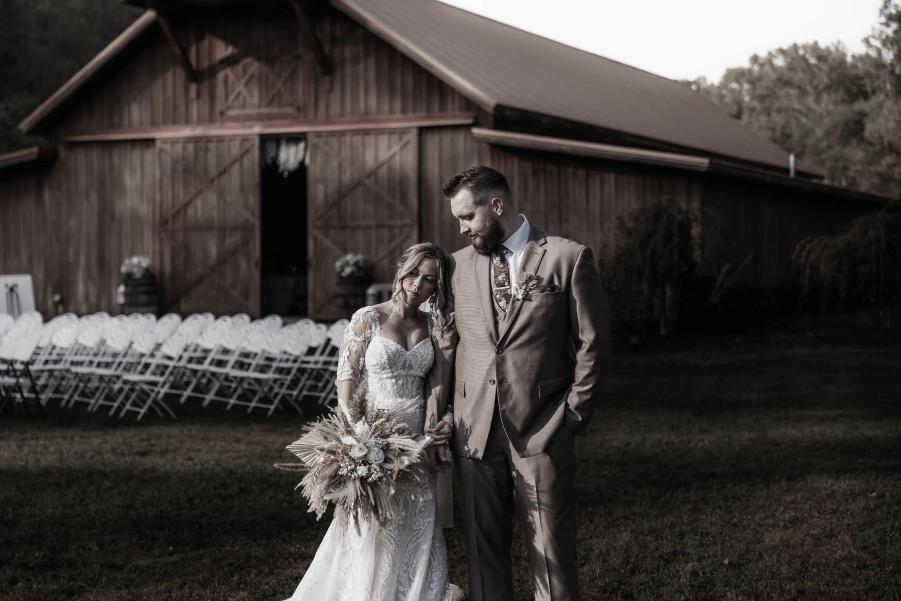 A room filled with white and gold balloons and a sign.