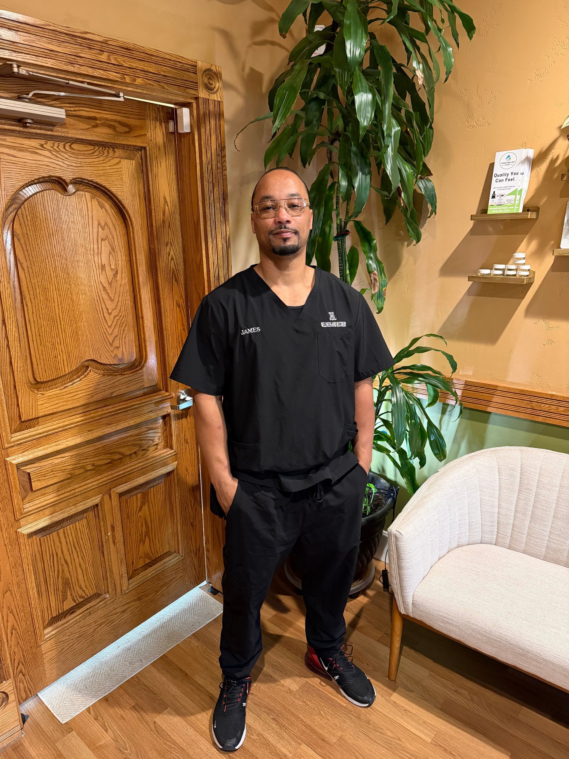 A woman with red hair is smiling while sitting in a car.