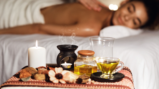 A woman is laying on a bed getting a massage.