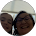Two people are standing next to each other in a circle and smiling.