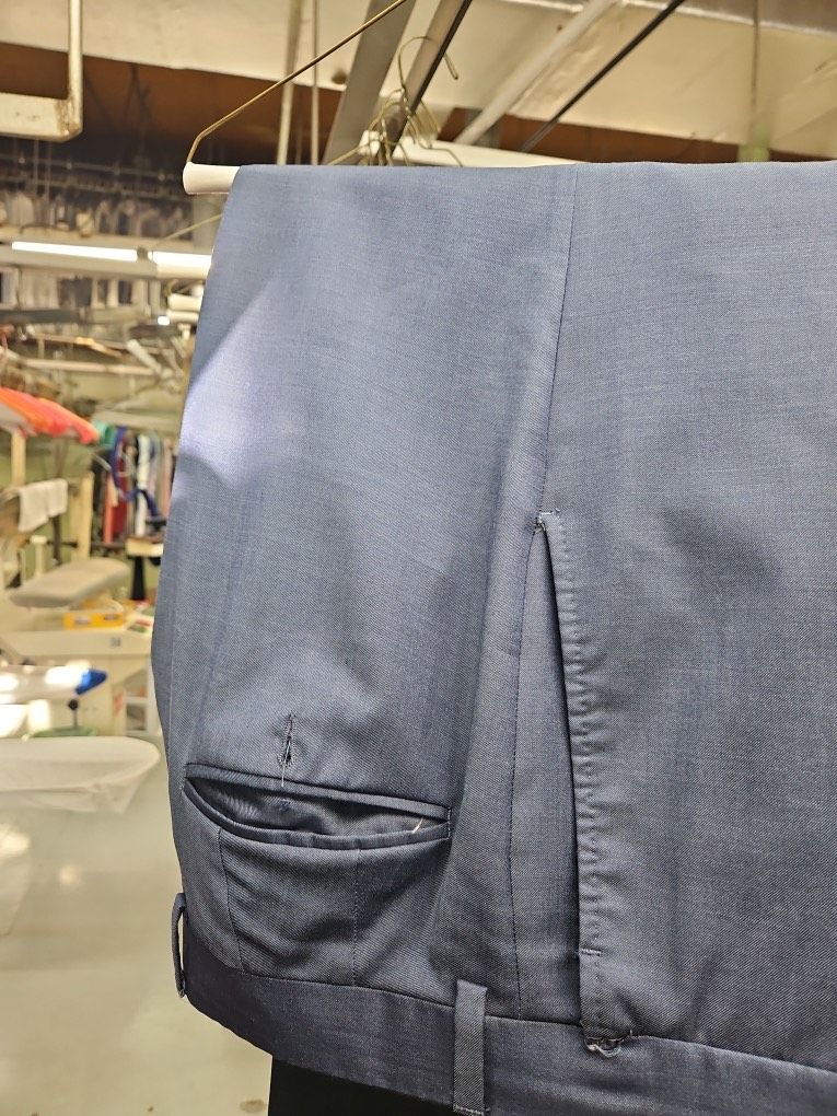 A pair of blue pants hanging on a rack