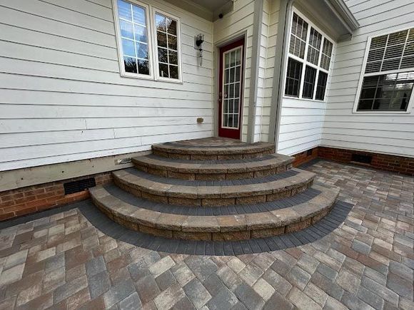 A set of stairs leading up to the front door of a house.