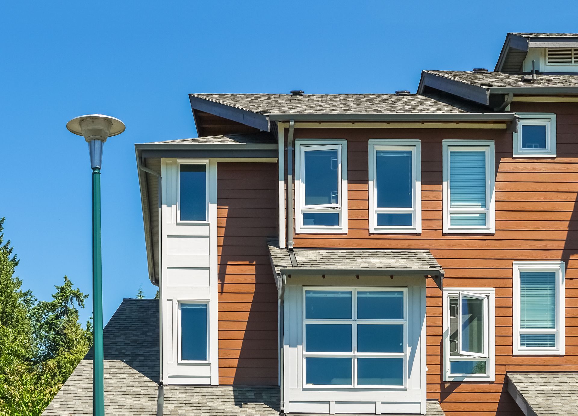 A large house with a lot of windows and a street light in front of it.