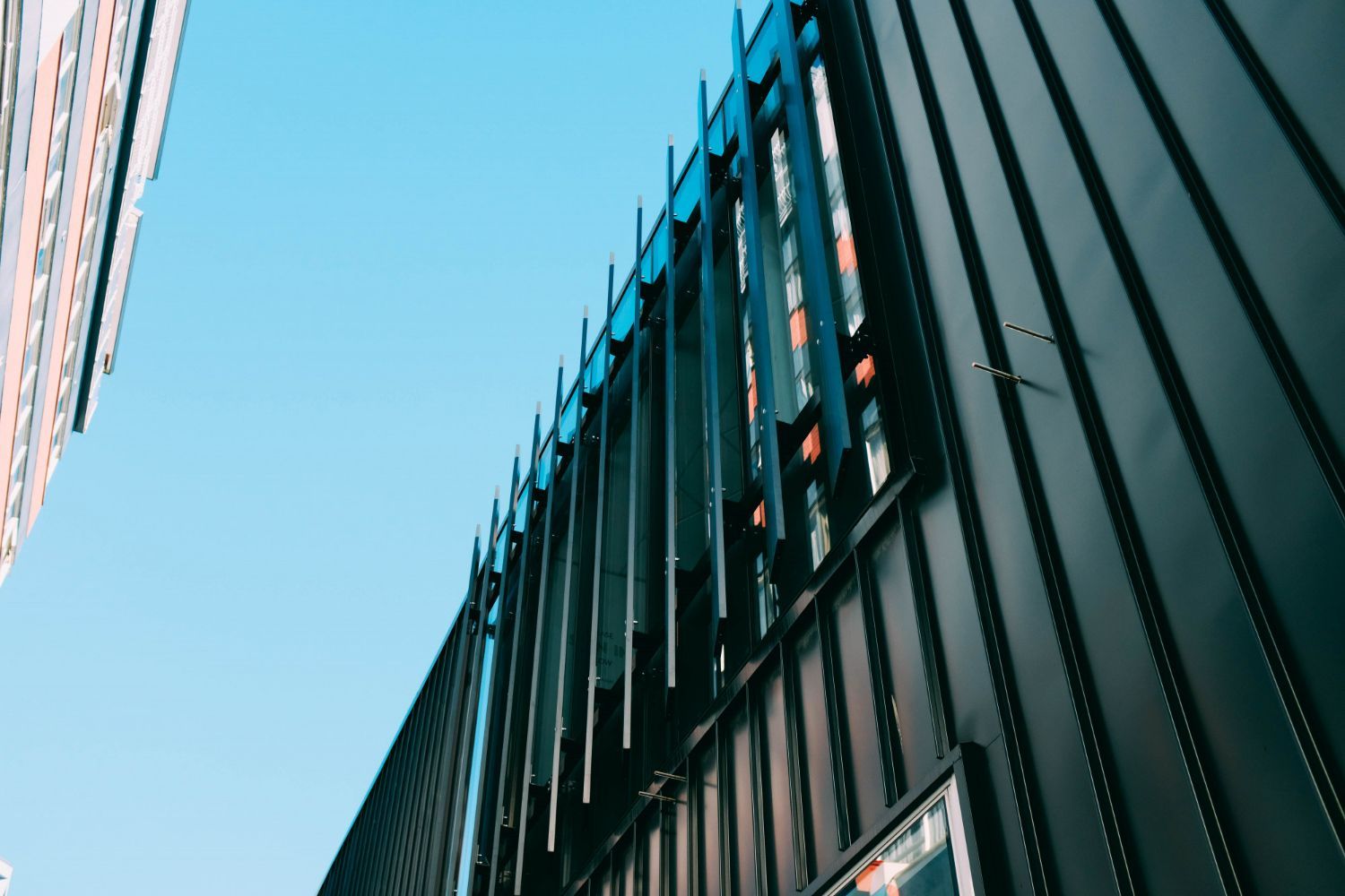 Looking up at a building with a blue sky in the background.