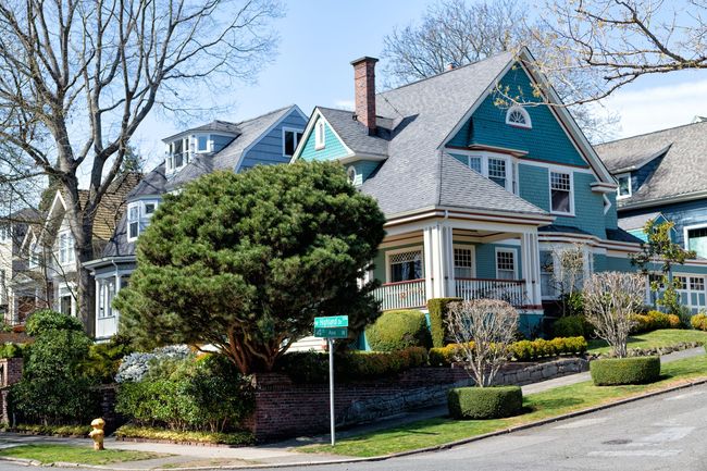 A row of houses on a sunny day in a residential neighborhood.