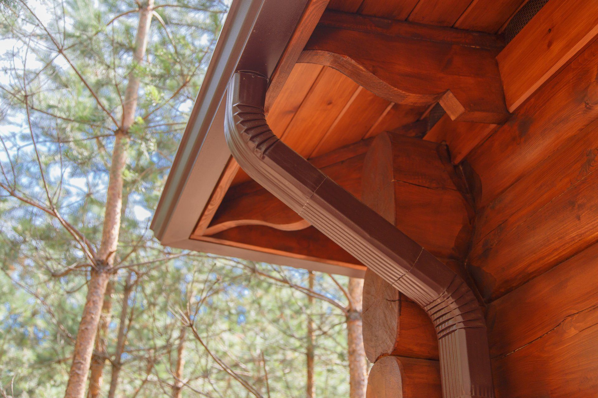 A log cabin with a gutter on the side of it.