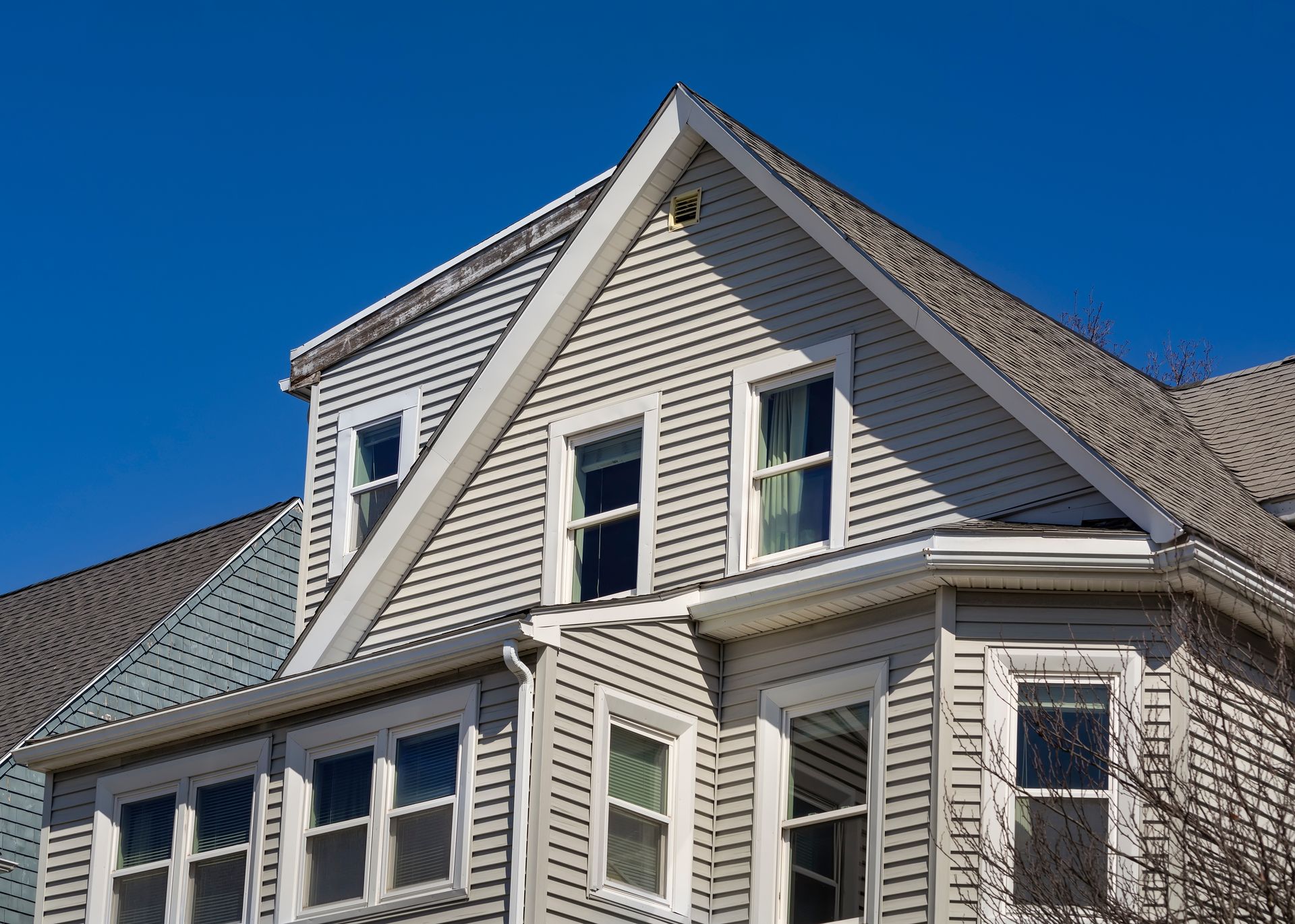 A large house with a blue sky in the background