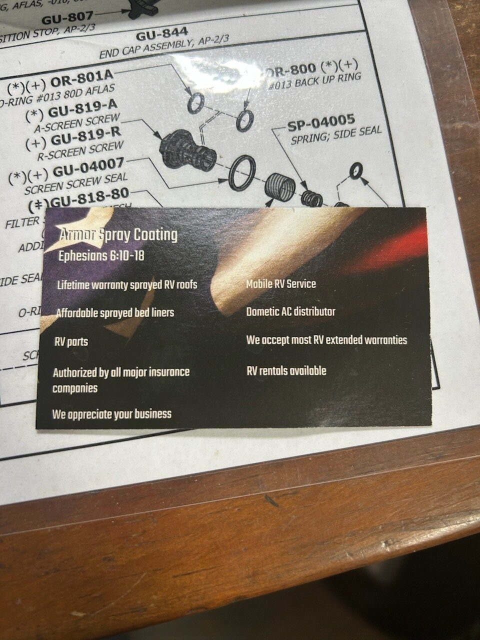 A business card laying on top of a piece of paper