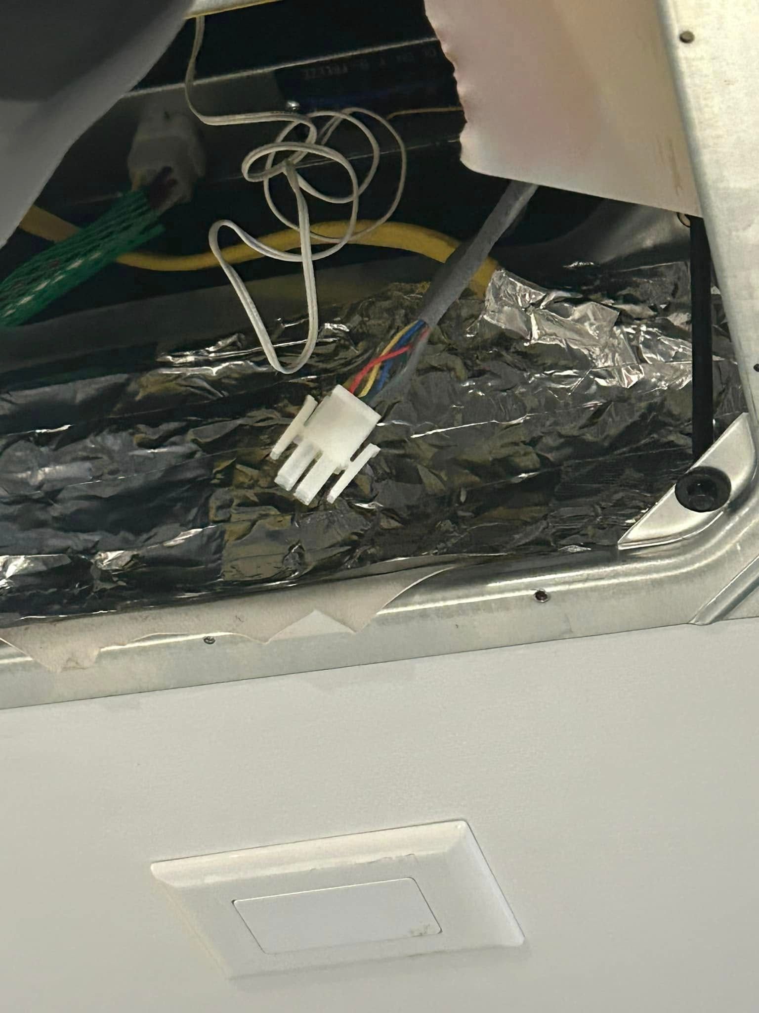 A close up of a electrical outlet with wires coming out of it.