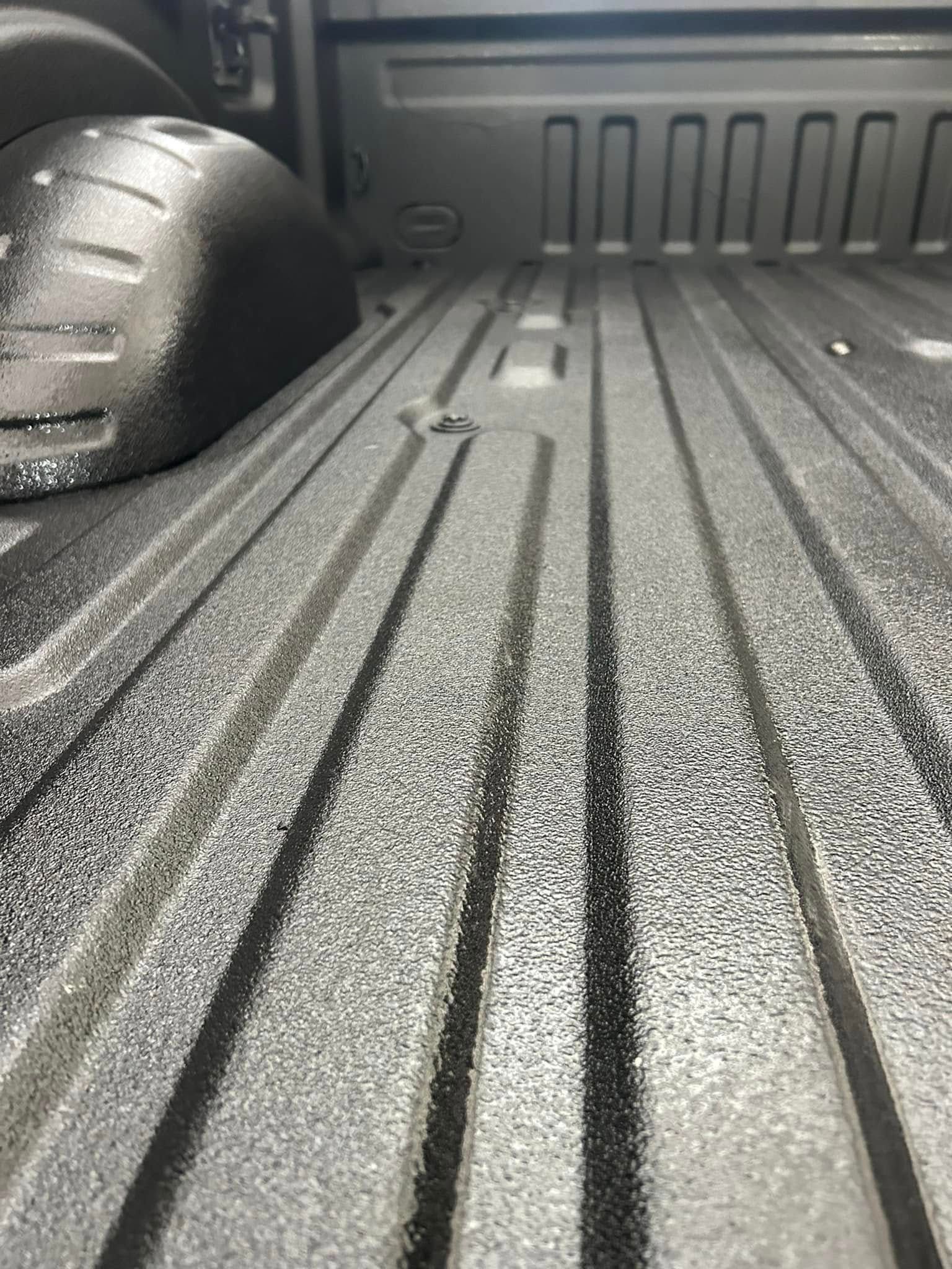 A close up of a truck bed with a lot of lines on it.