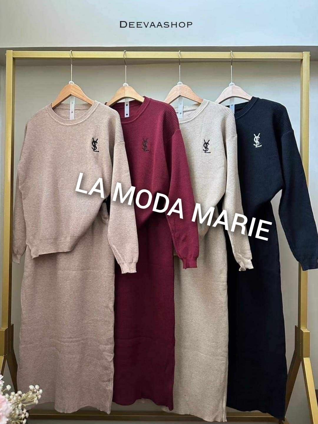 A row of sweaters and skirts hanging on a rack.