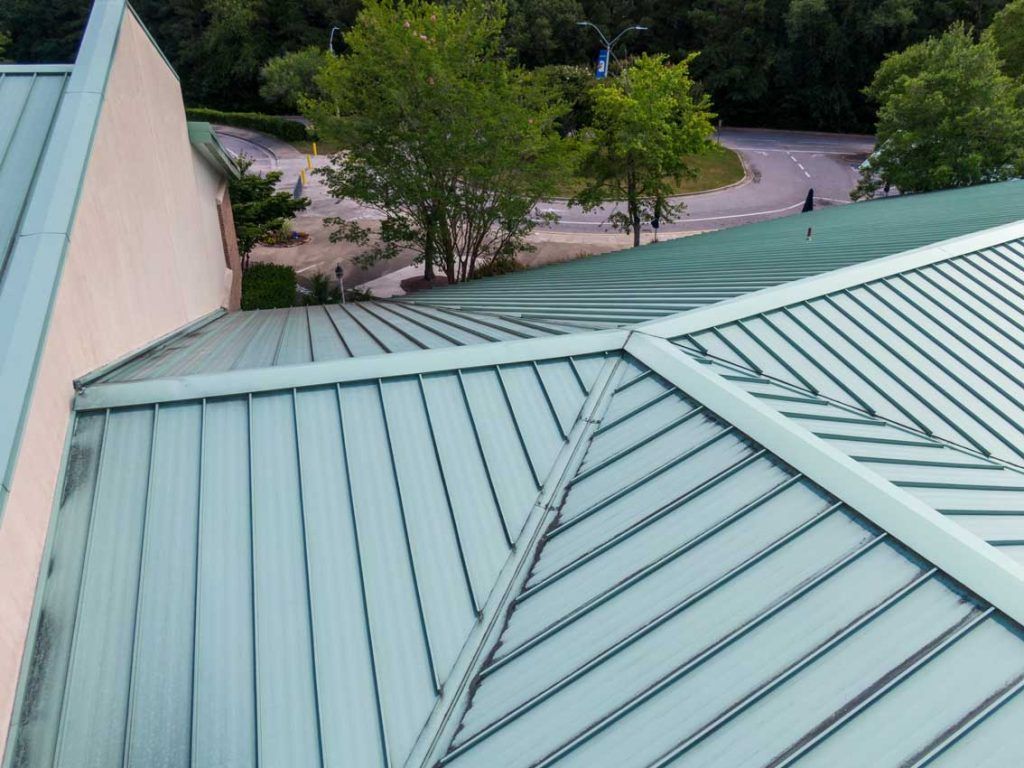 An aerial view of a roof with trees in the background