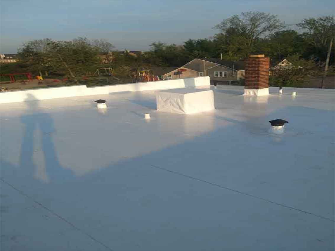 A white roof with a chimney on top of it.