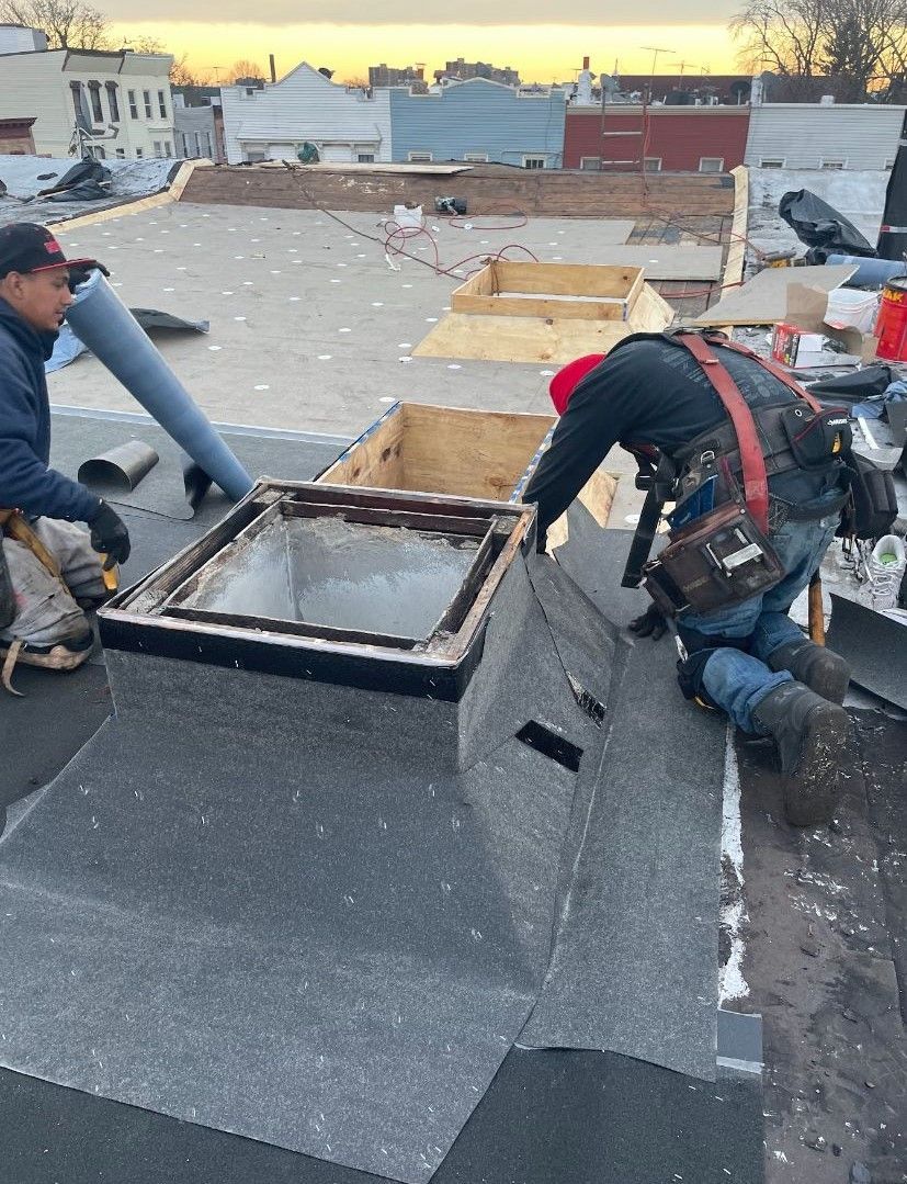 A couple of men are working on a roof.