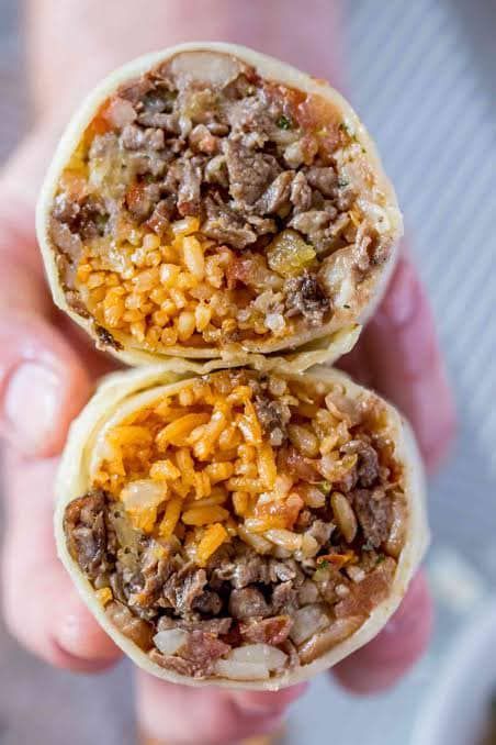 A Person is Holding Two Burritos in Their Hands — Cafe Nosh in Taree, NSW