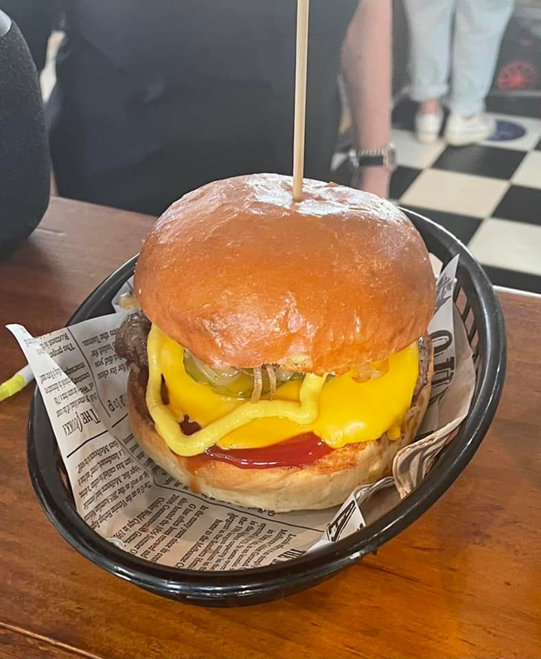 A Hamburger is Sitting in a Bowl on a Table — Cafe Nosh in Taree, NSW