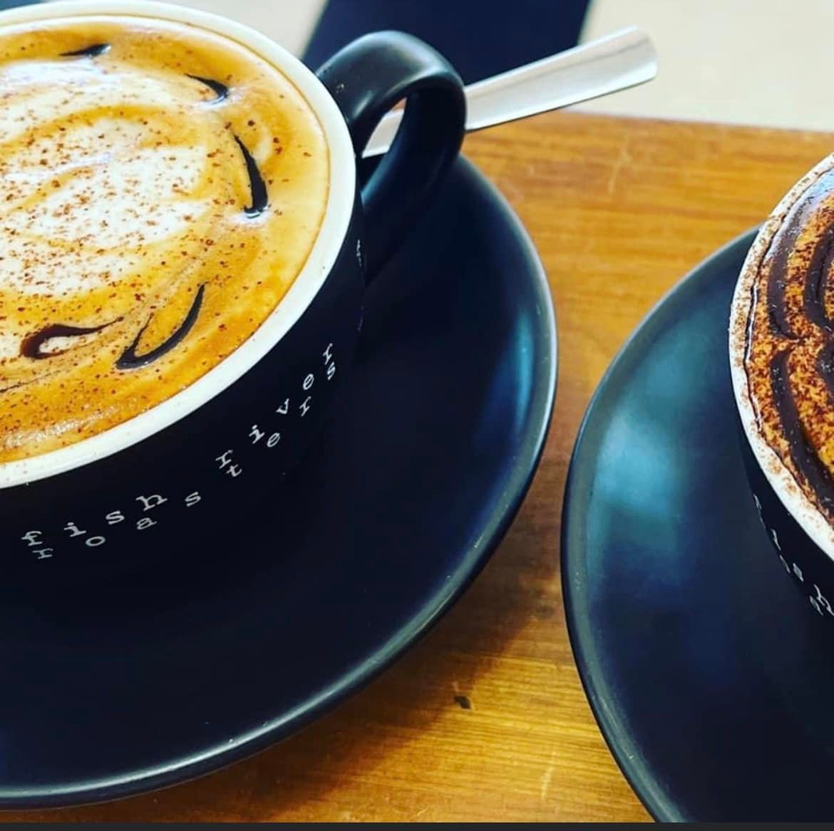 Two Cups of Coffee Are on a Saucer on a Table — Cafe Nosh in Taree, NSW