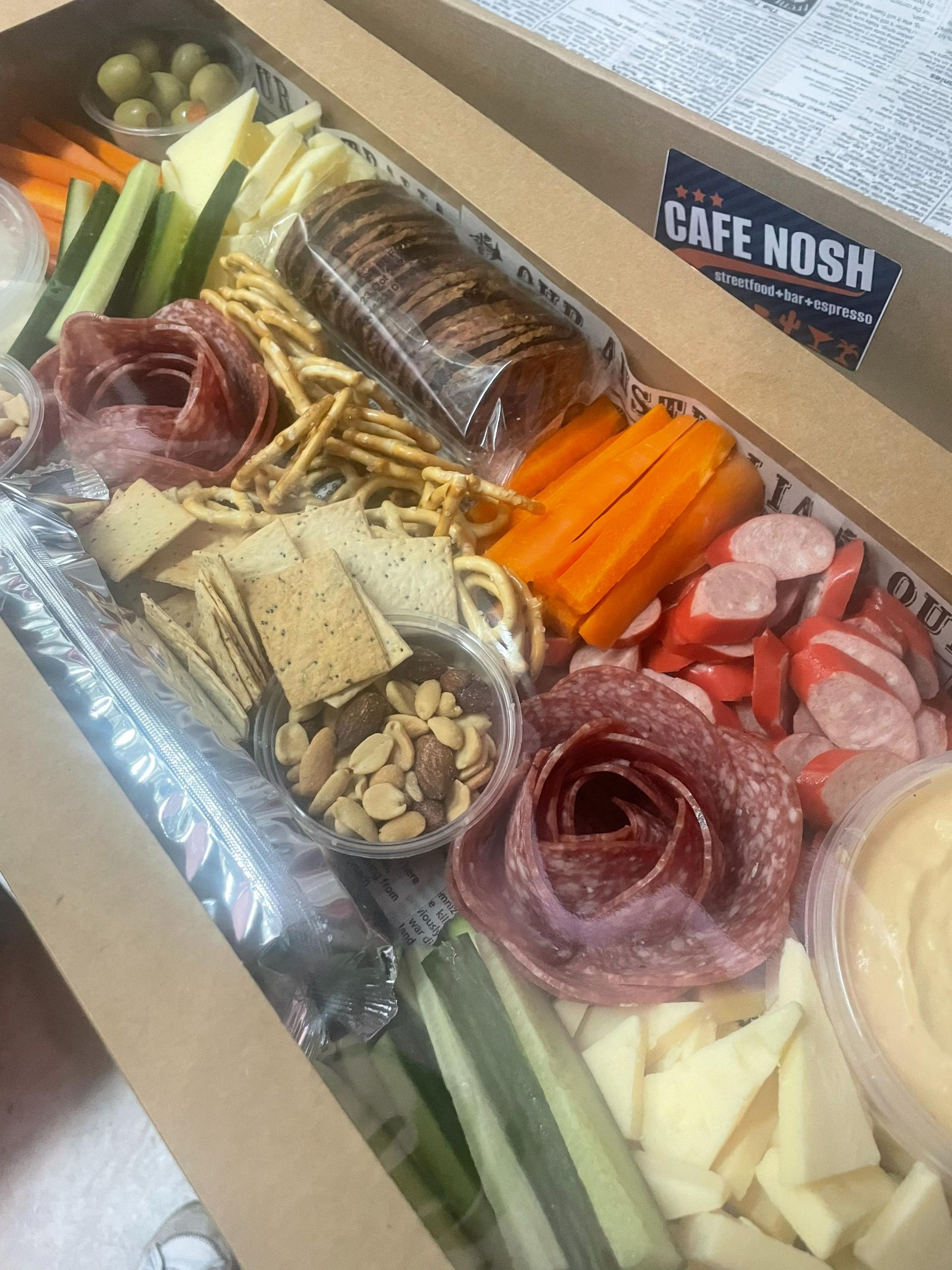 A Plate of Food With Eggs Benedict and Smoked Salmon on a Table — Cafe Nosh in Taree, NSW