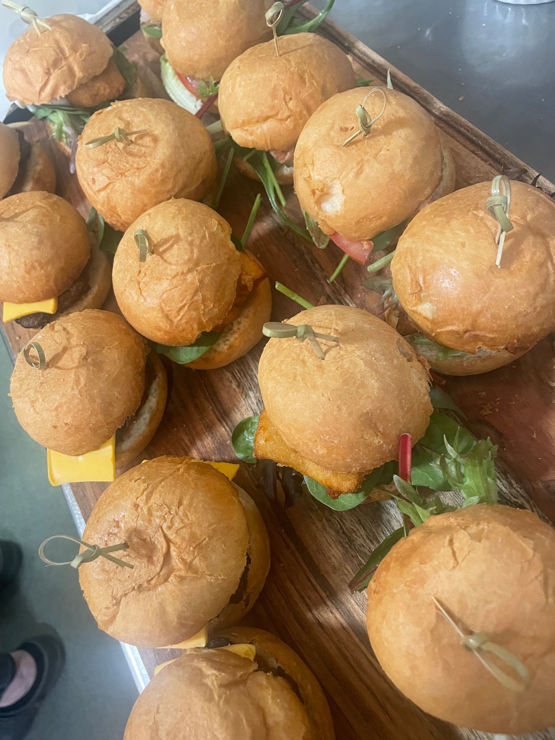A Plate of Food With Avocado , Poached Eggs and Tomatoes on a Table — Cafe Nosh in Taree, NSW