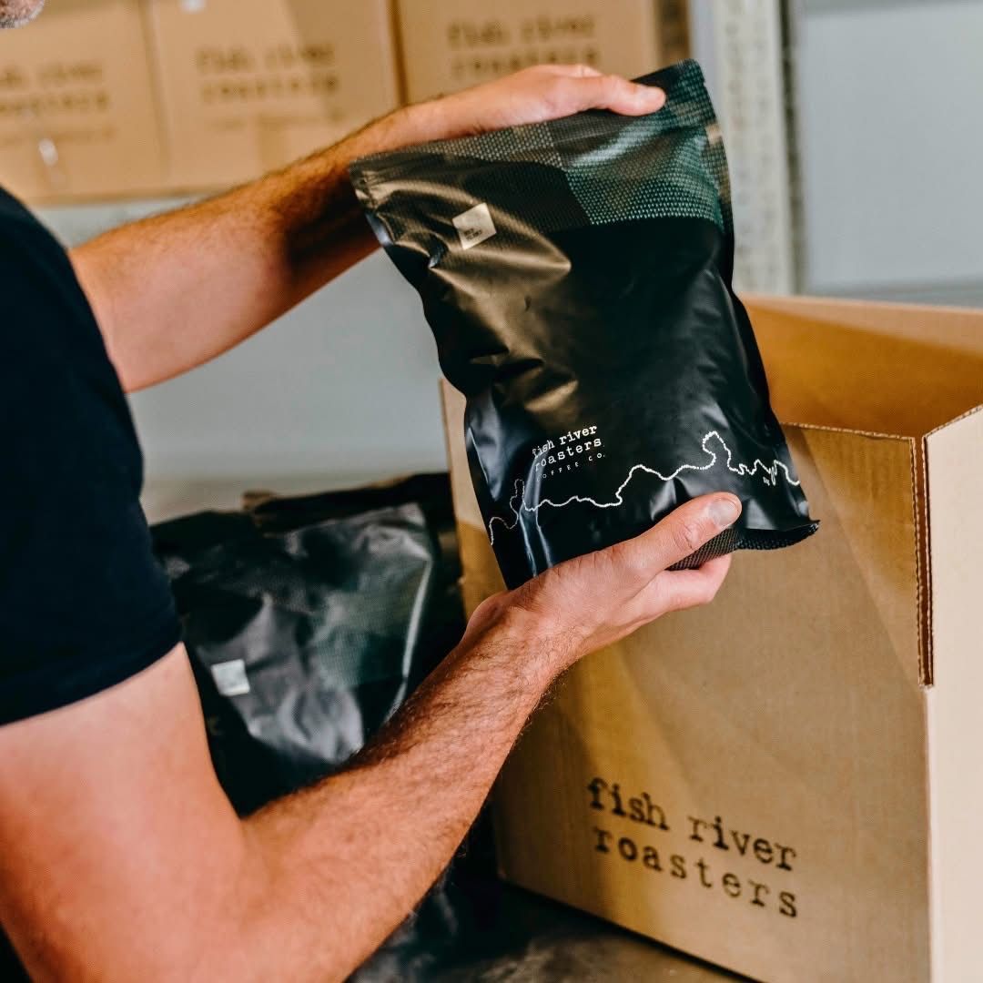 A Box of Fish and Chips With a Newspaper Wrapped in It — Cafe Nosh in Taree, NSW