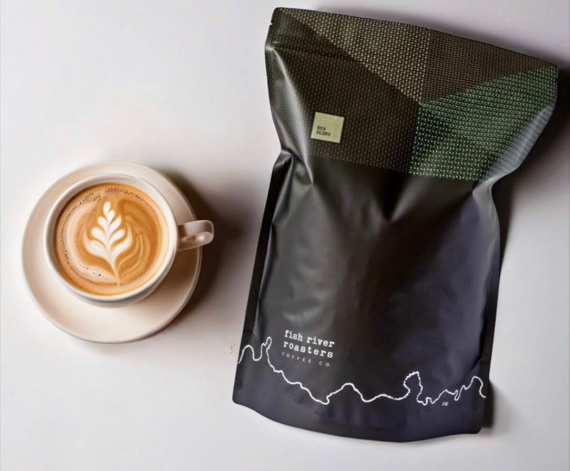 An Above Shot Of A Coffee Mug And A Coffee Bag Next To It — Cafe Nosh in Taree, NSW