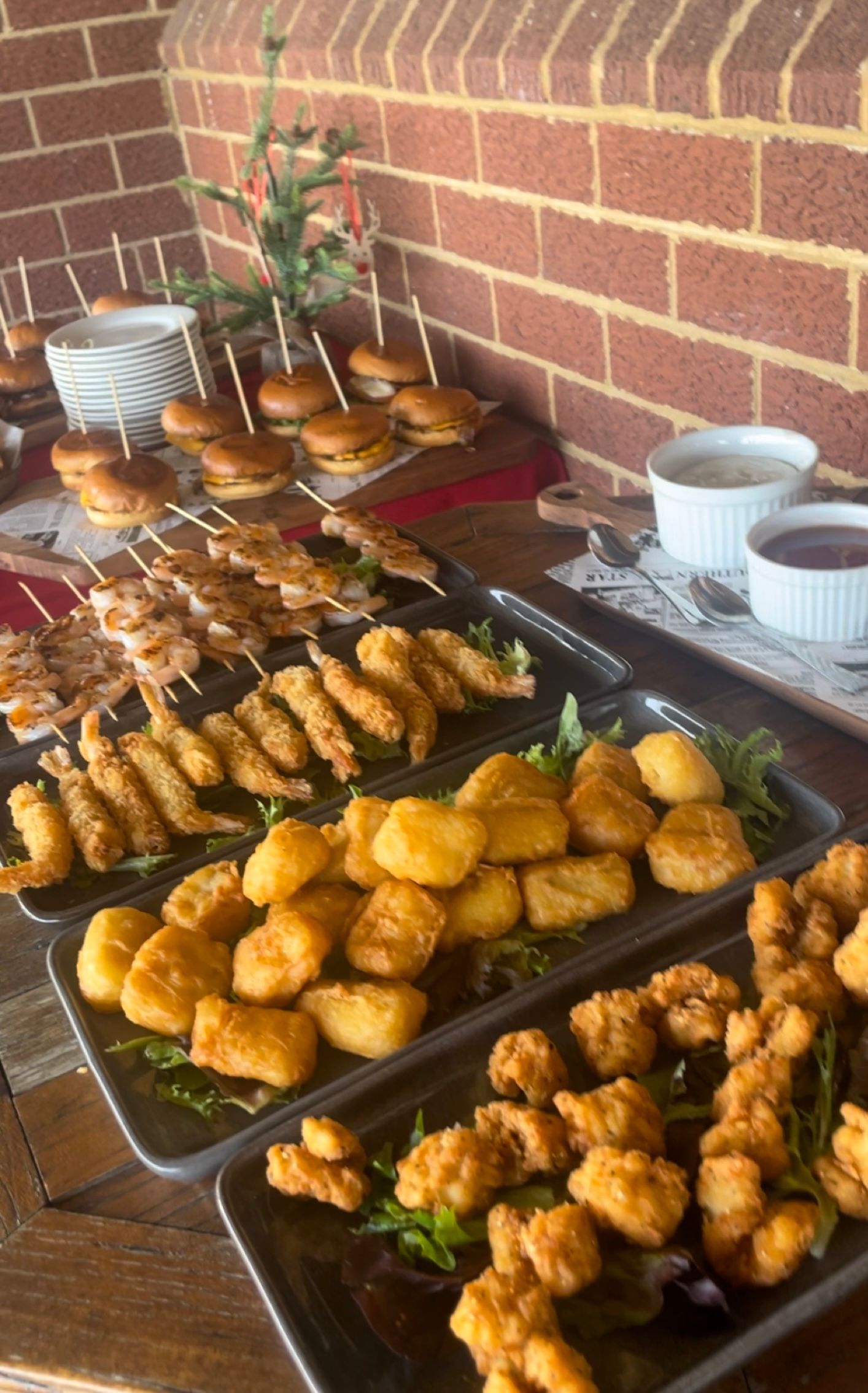 A Table Topped With Plates of Food and a Bottle of Beer — Cafe Nosh in Taree, NSW