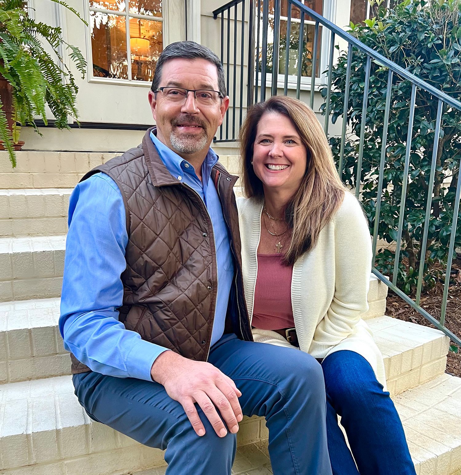 A man and a woman are sitting on a set of stairs