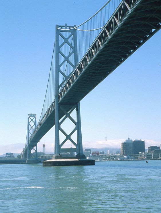 A bridge over a body of water with a blue sky in the background