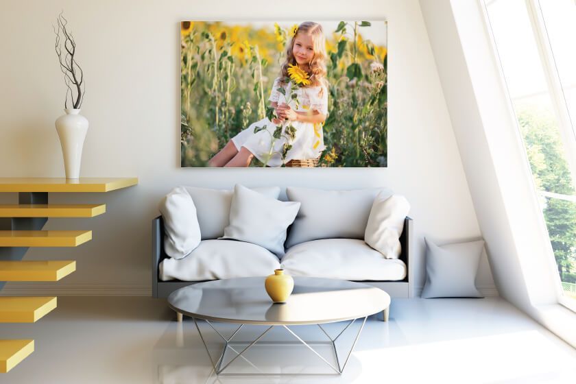 A living room with a couch and a canvas print on the wall