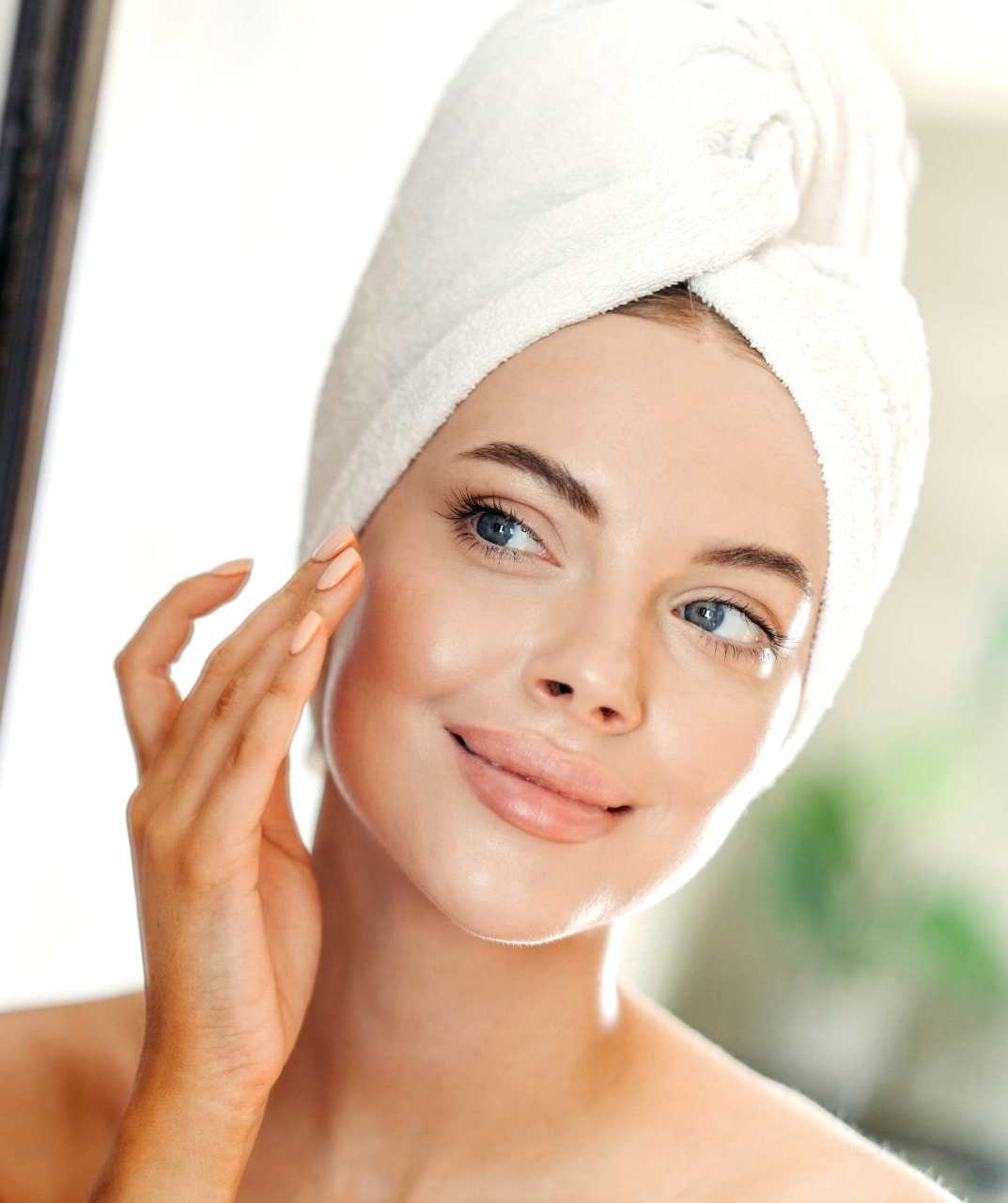 A satisfied woman touching her face after getting a treatment