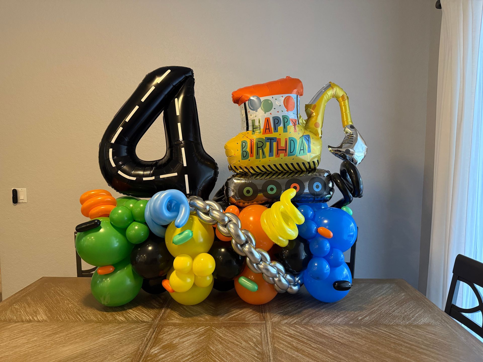 A bunch of balloons are stacked on top of each other on a table.