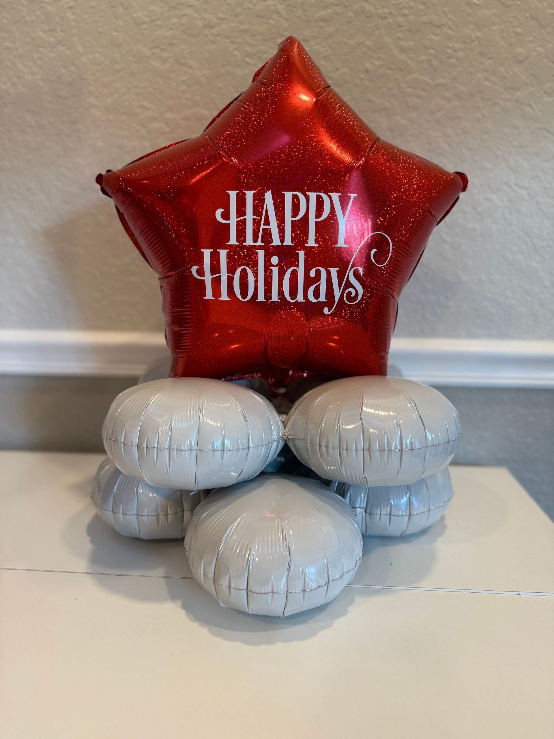 A red balloon with the words happy holidays on it