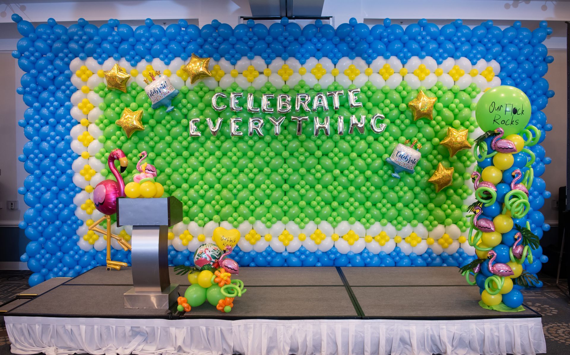 A wall of balloons with the words `` celebrate everything '' written on it.