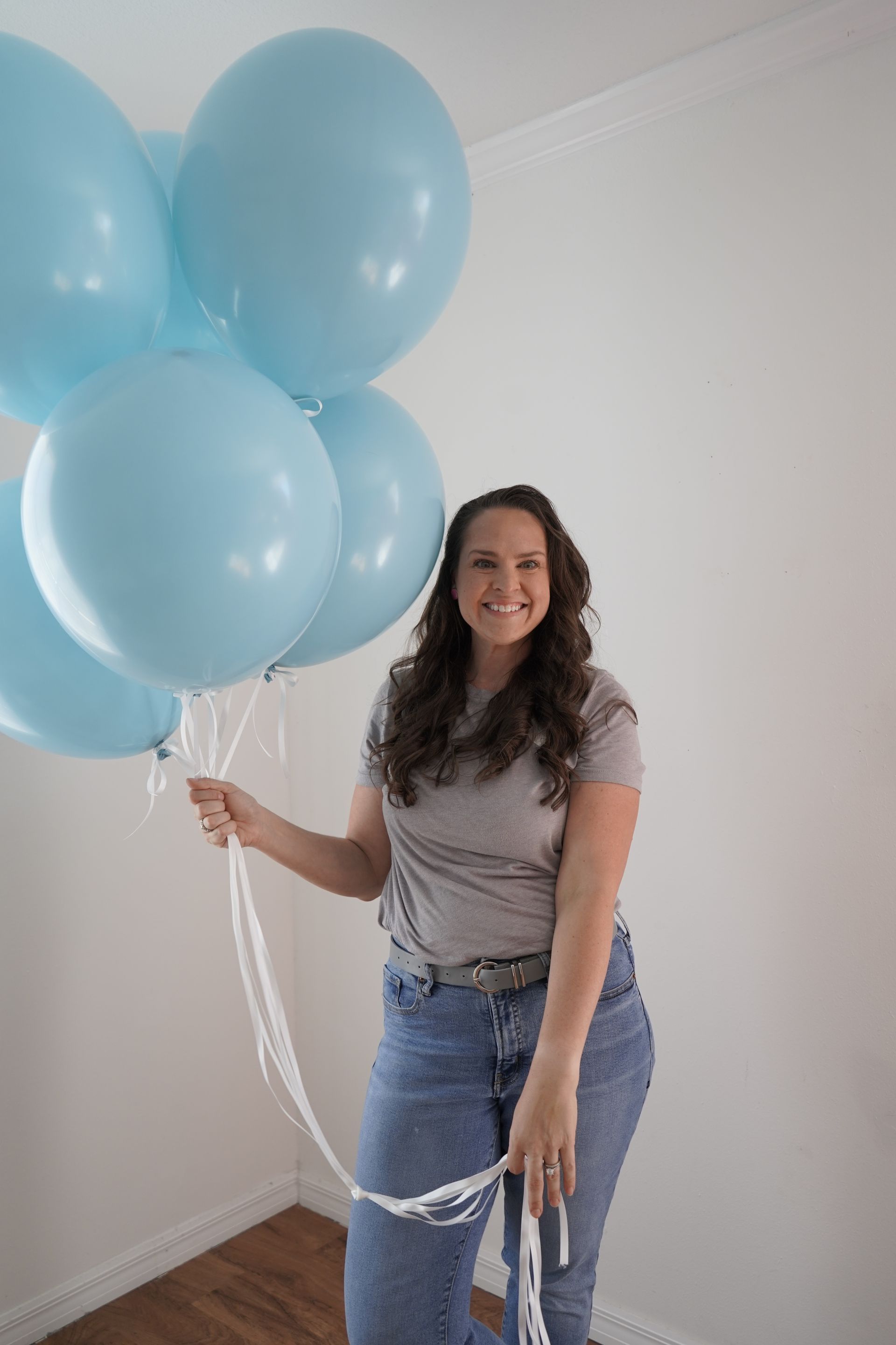 A bunch of balloons are sitting on a table in a room