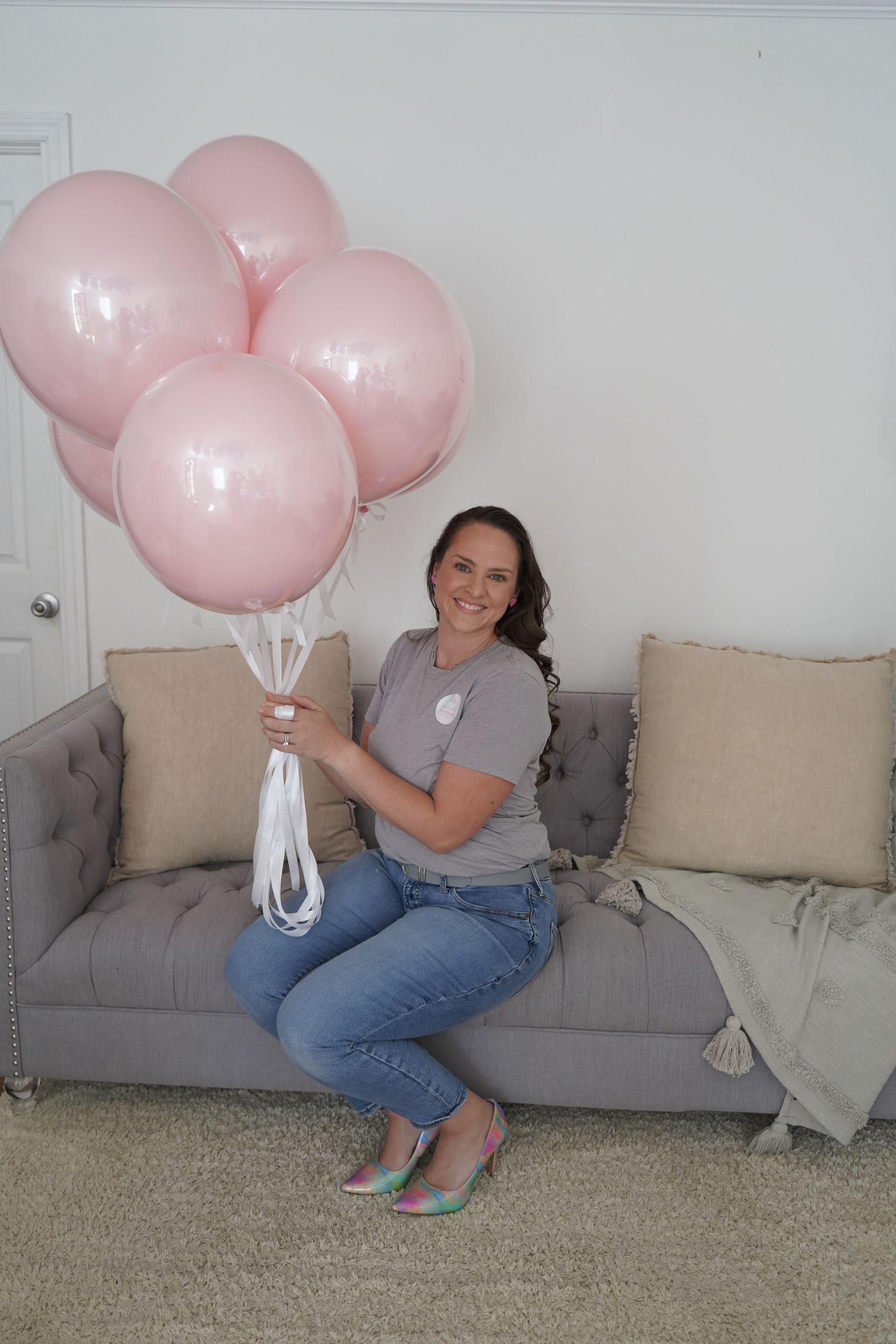 A bunch of silver balloons with black bows on them