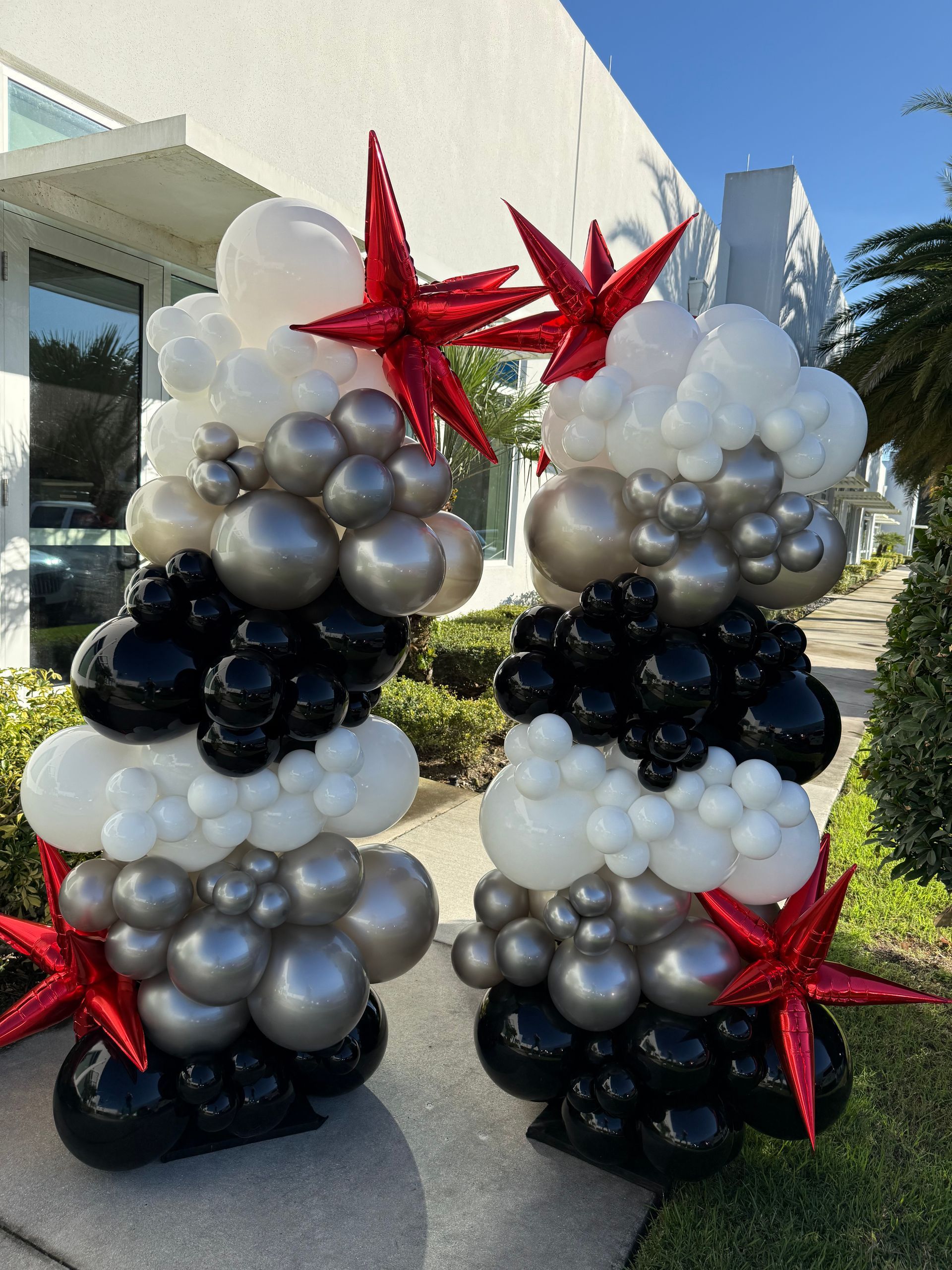 A couple of balloons stacked on top of each other on a sidewalk.